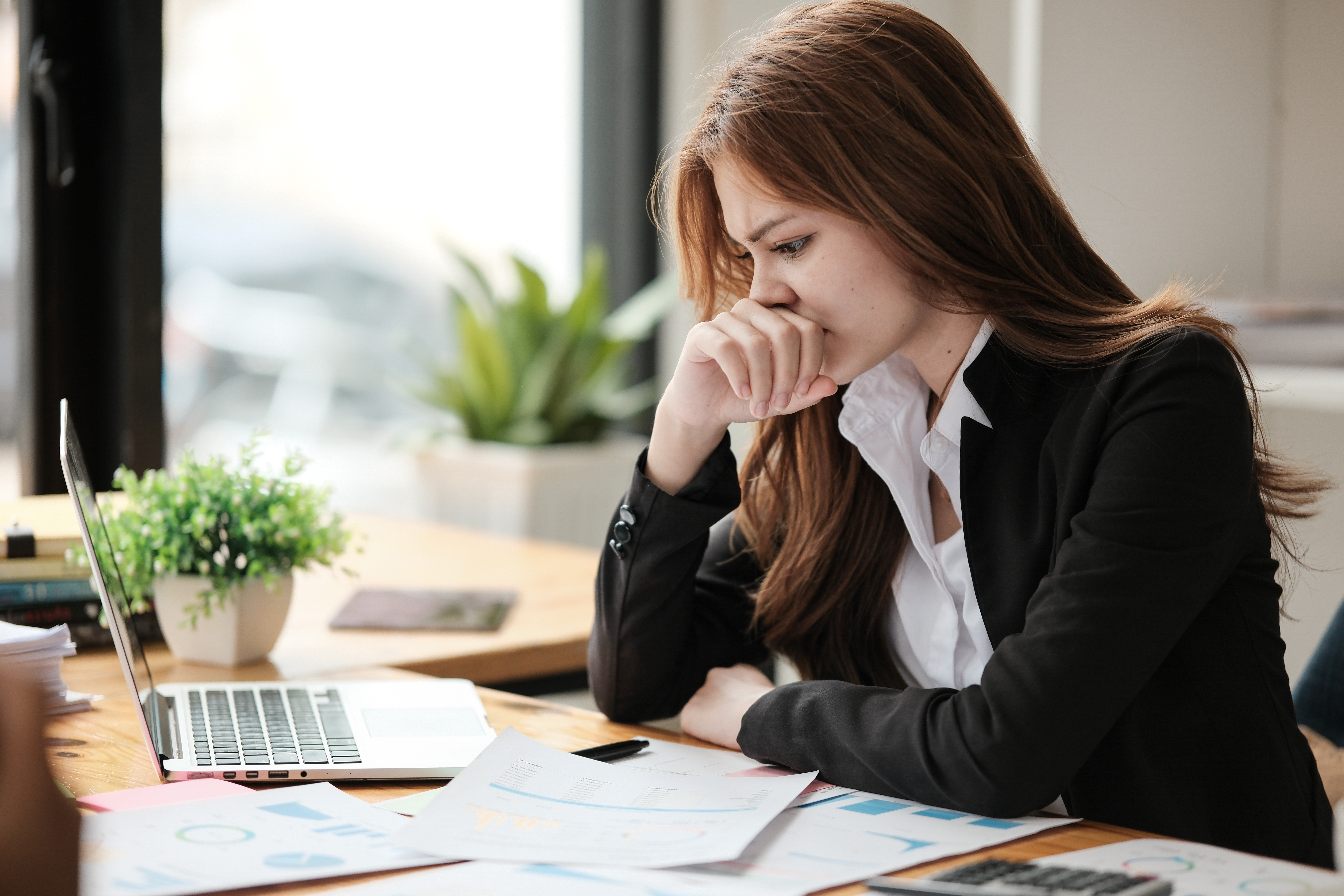Woman stressed, sitting at desk