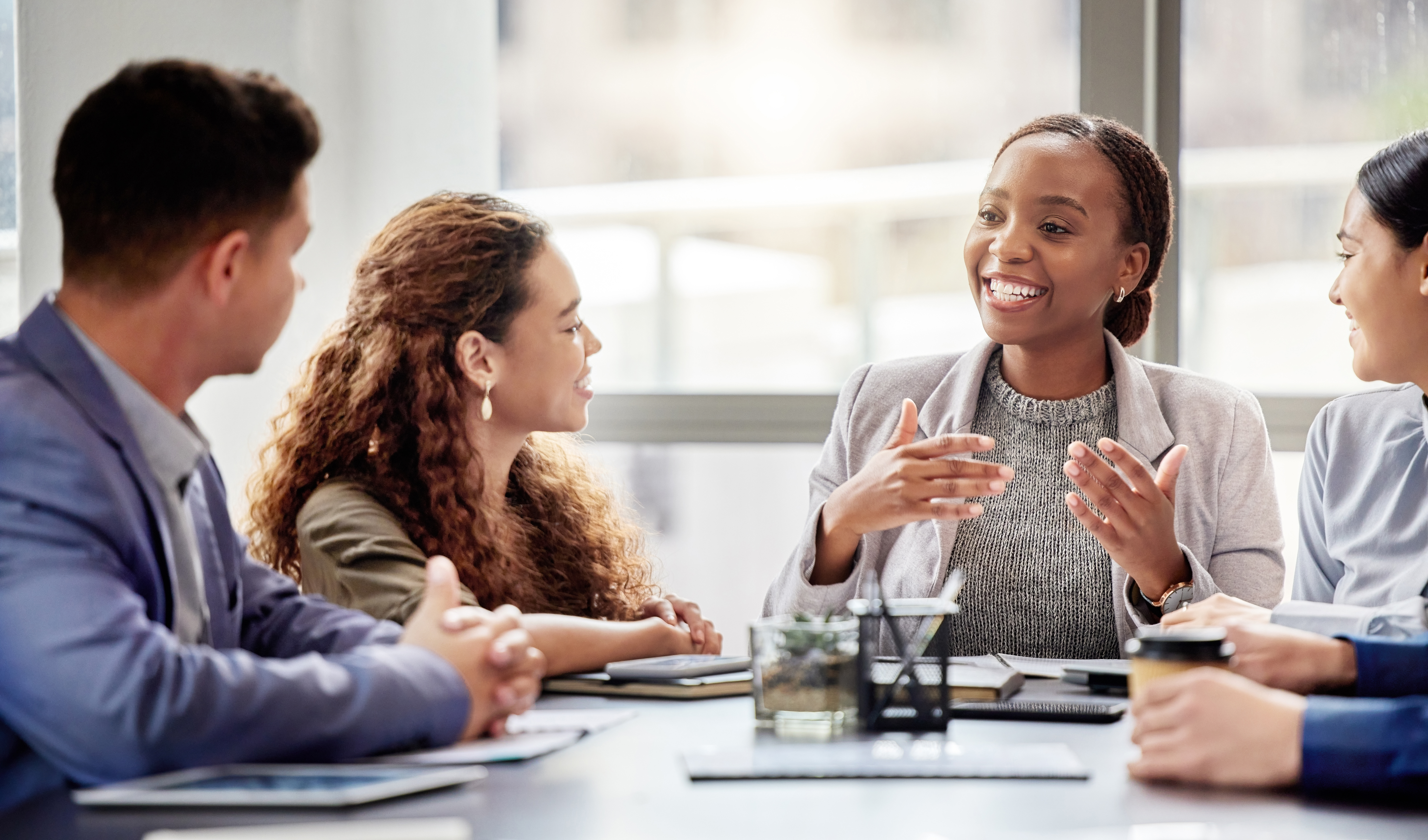 Employees sitting, smiling, working together