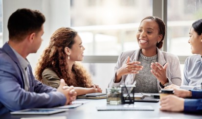 Employees sitting, smiling, working together