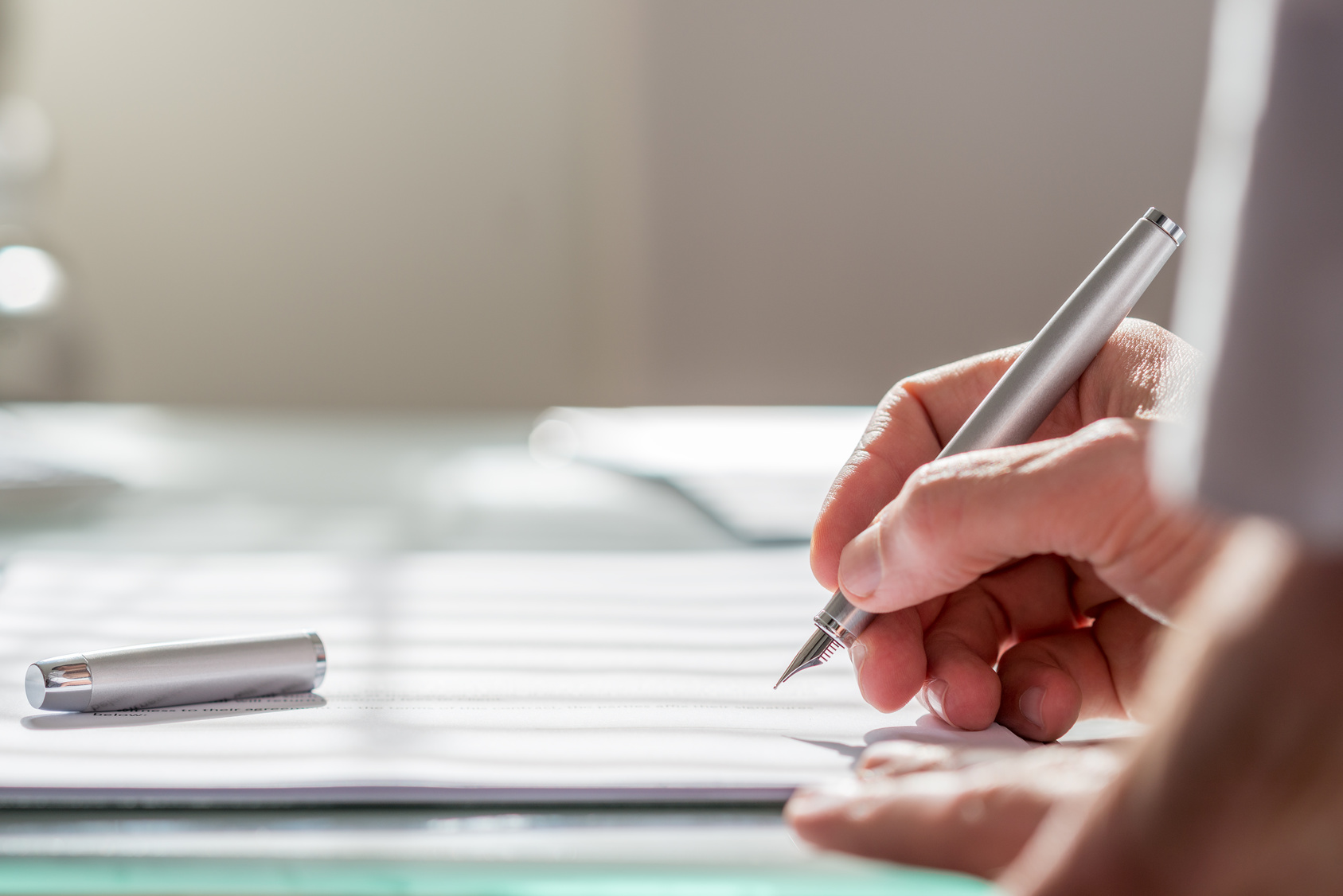 A person signing documents.