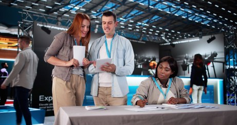 Woman getting information from a booth at event