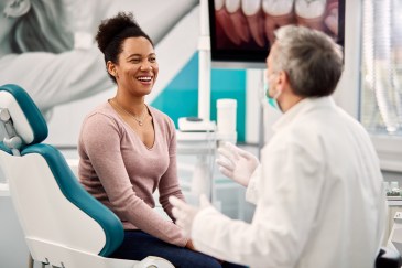 Woman at dentist, smiling, talking