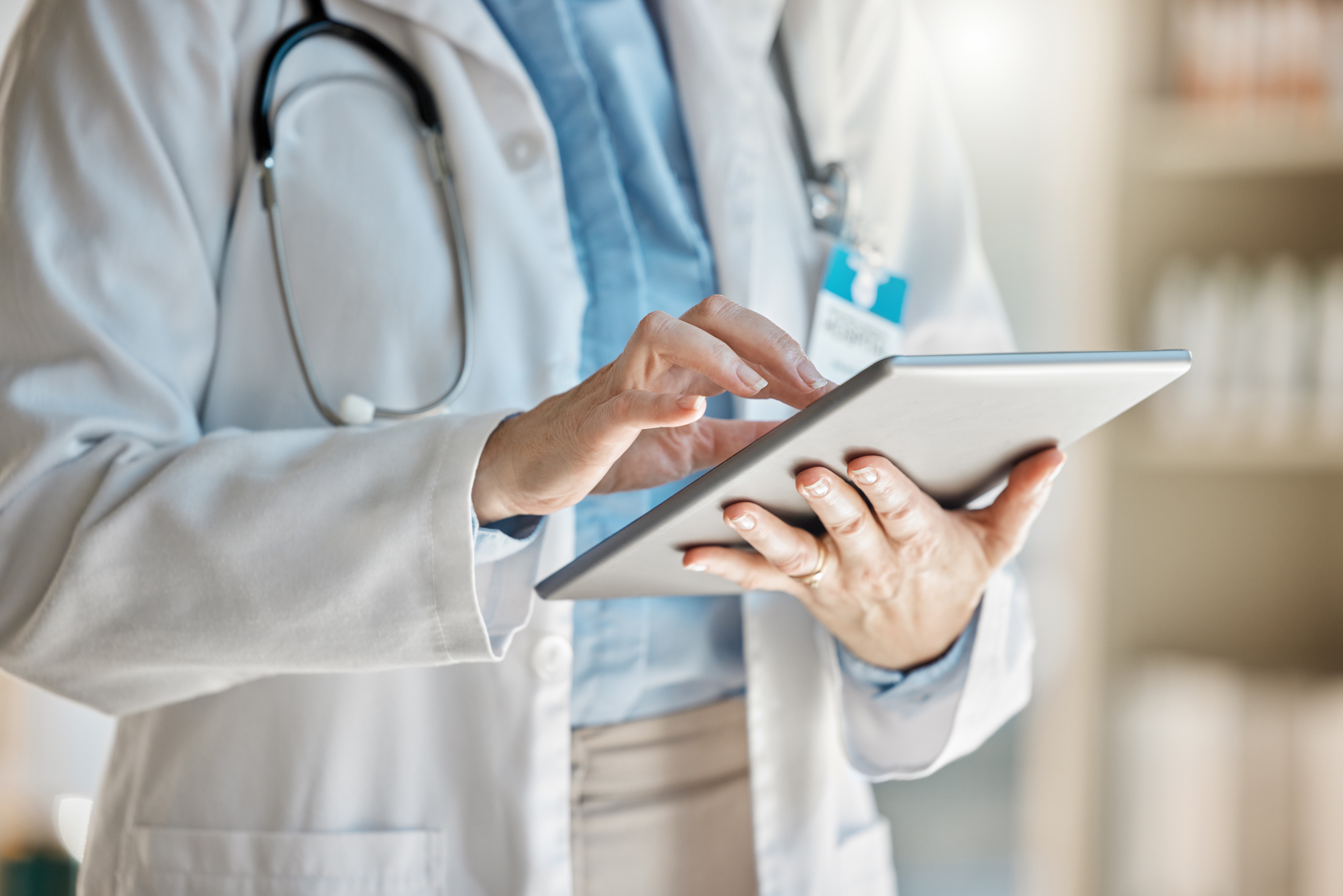 Doctor typing in iPad