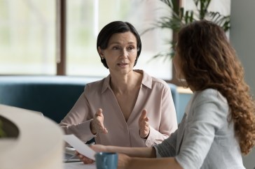 Two female employees talking