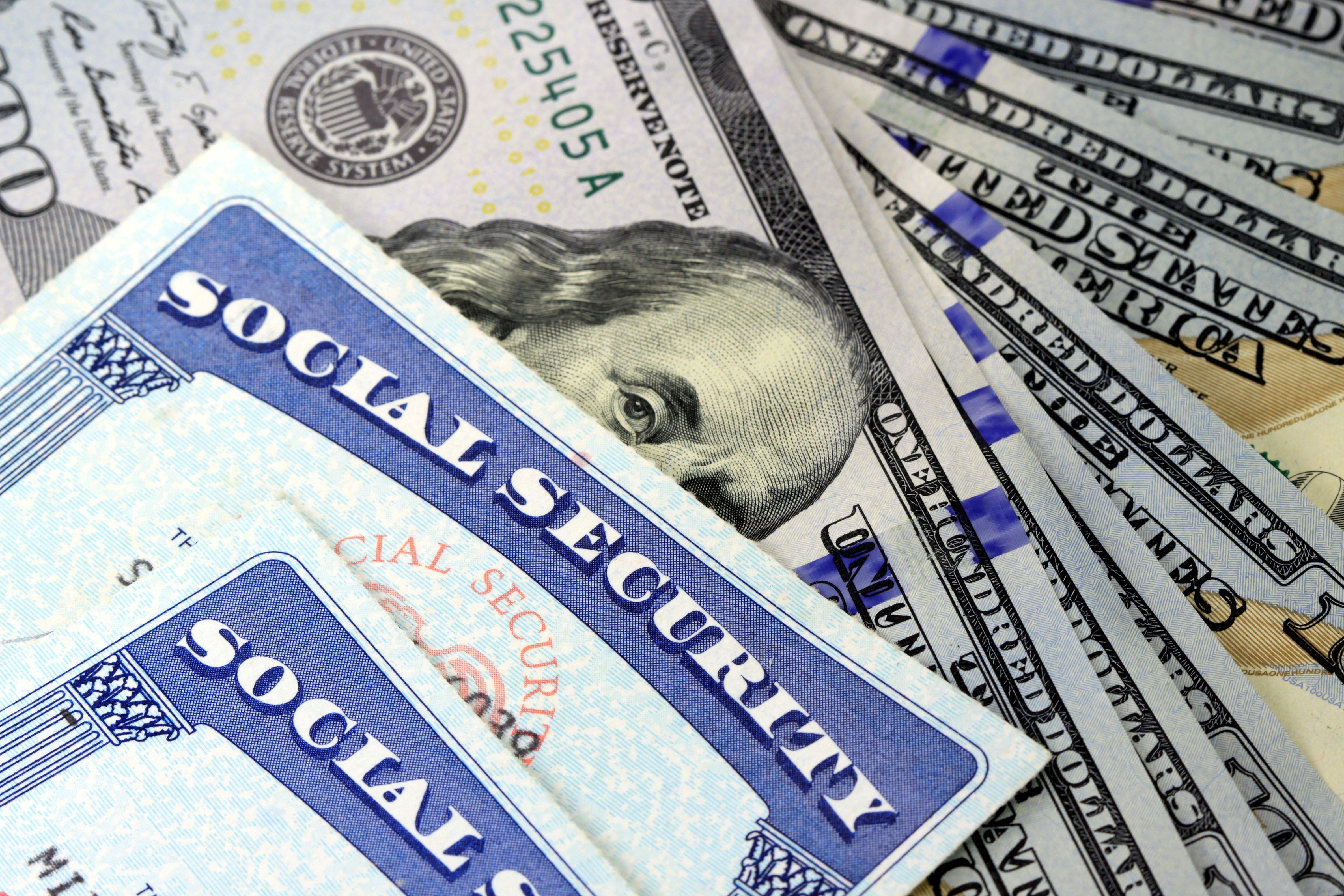 Social security cards and one hundred dollar bills.
