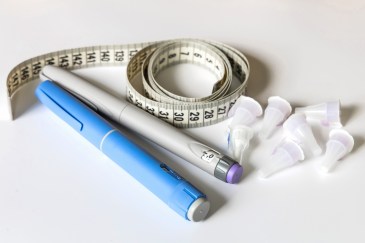 GLP-1 medication and a tape measure.