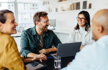 Group of employees sitting at table