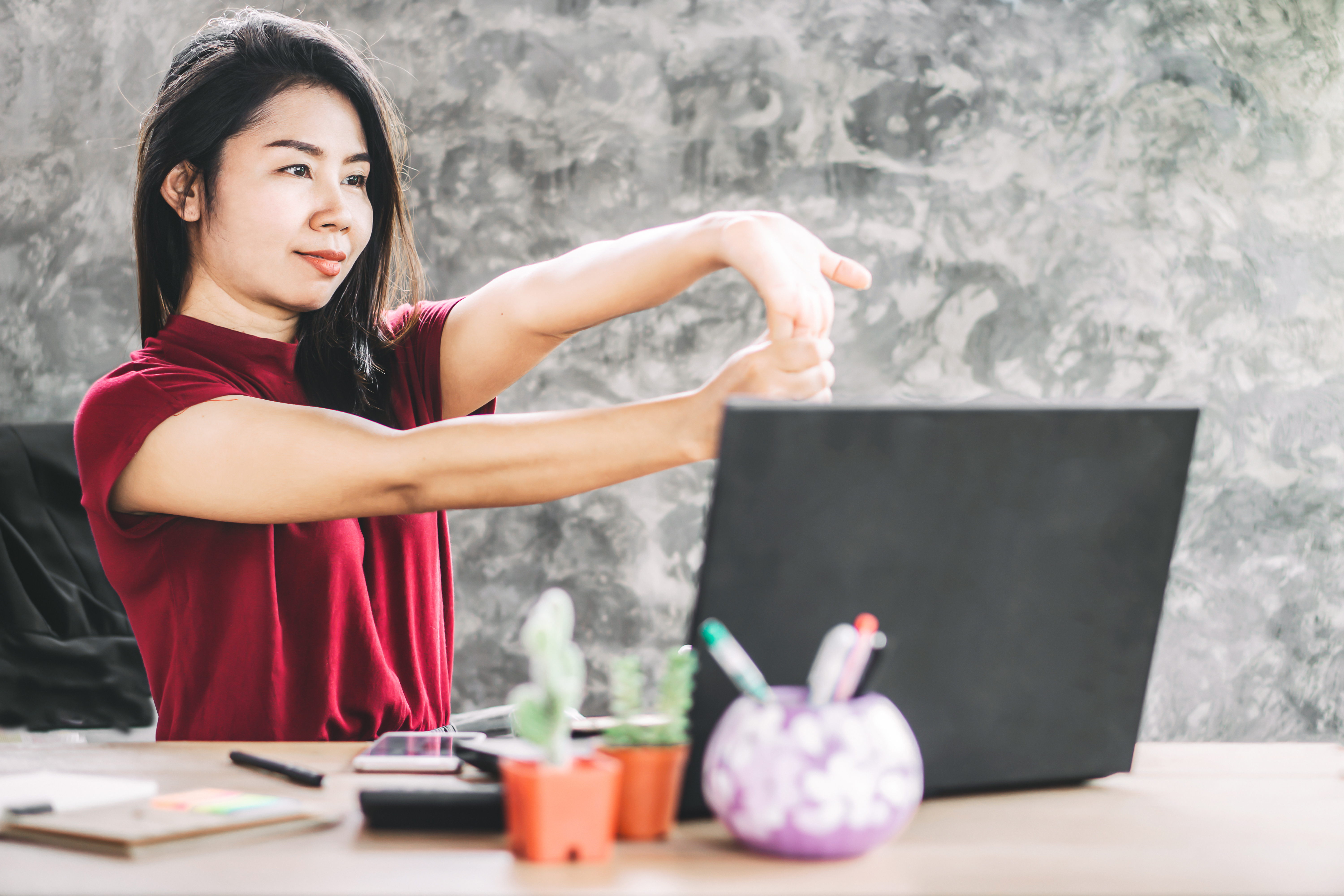 Woman stretching at her desk