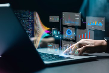 A man works on a laptop with images of AI technology hovering overhead.