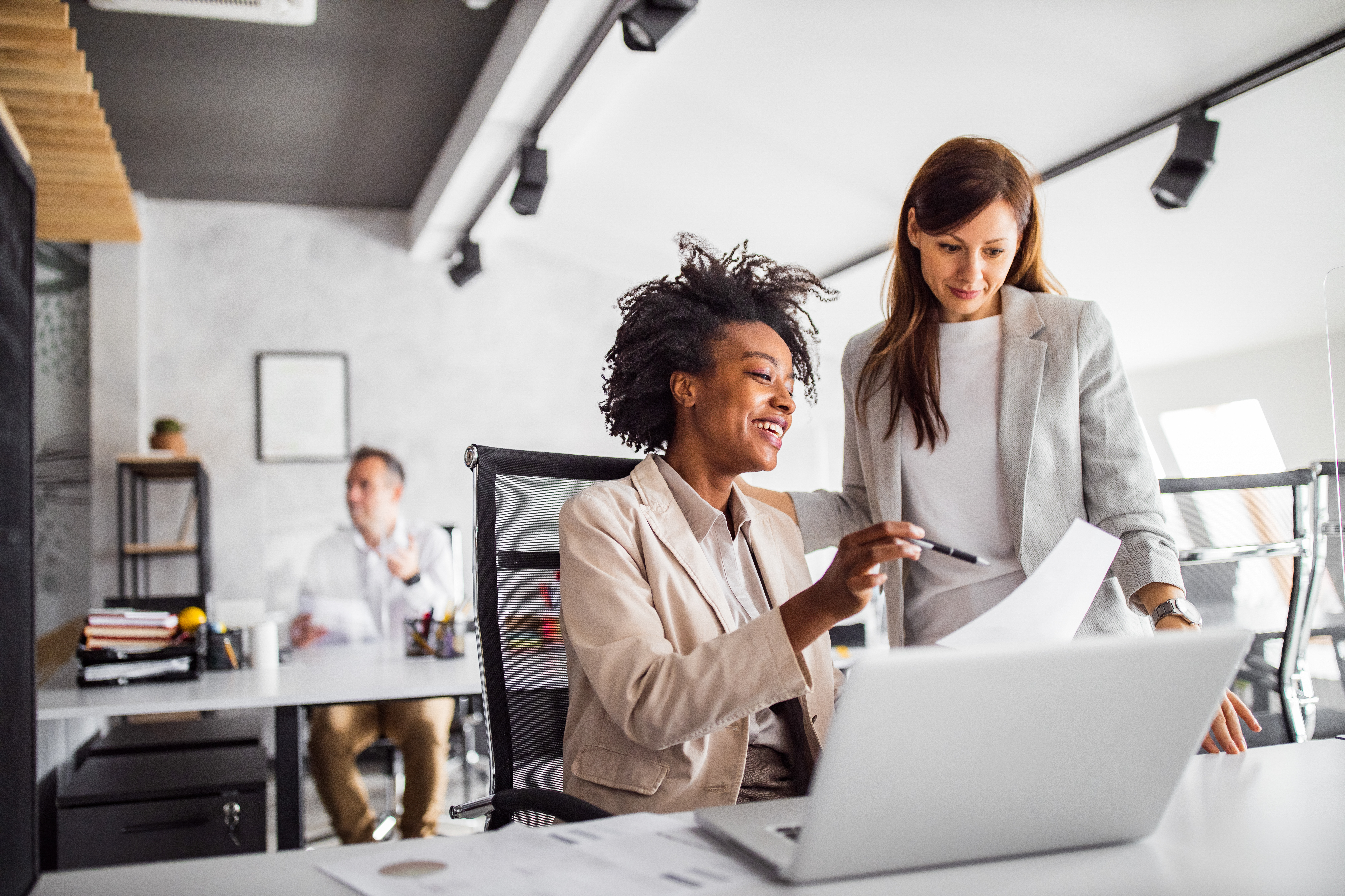 Women looking over documents at work