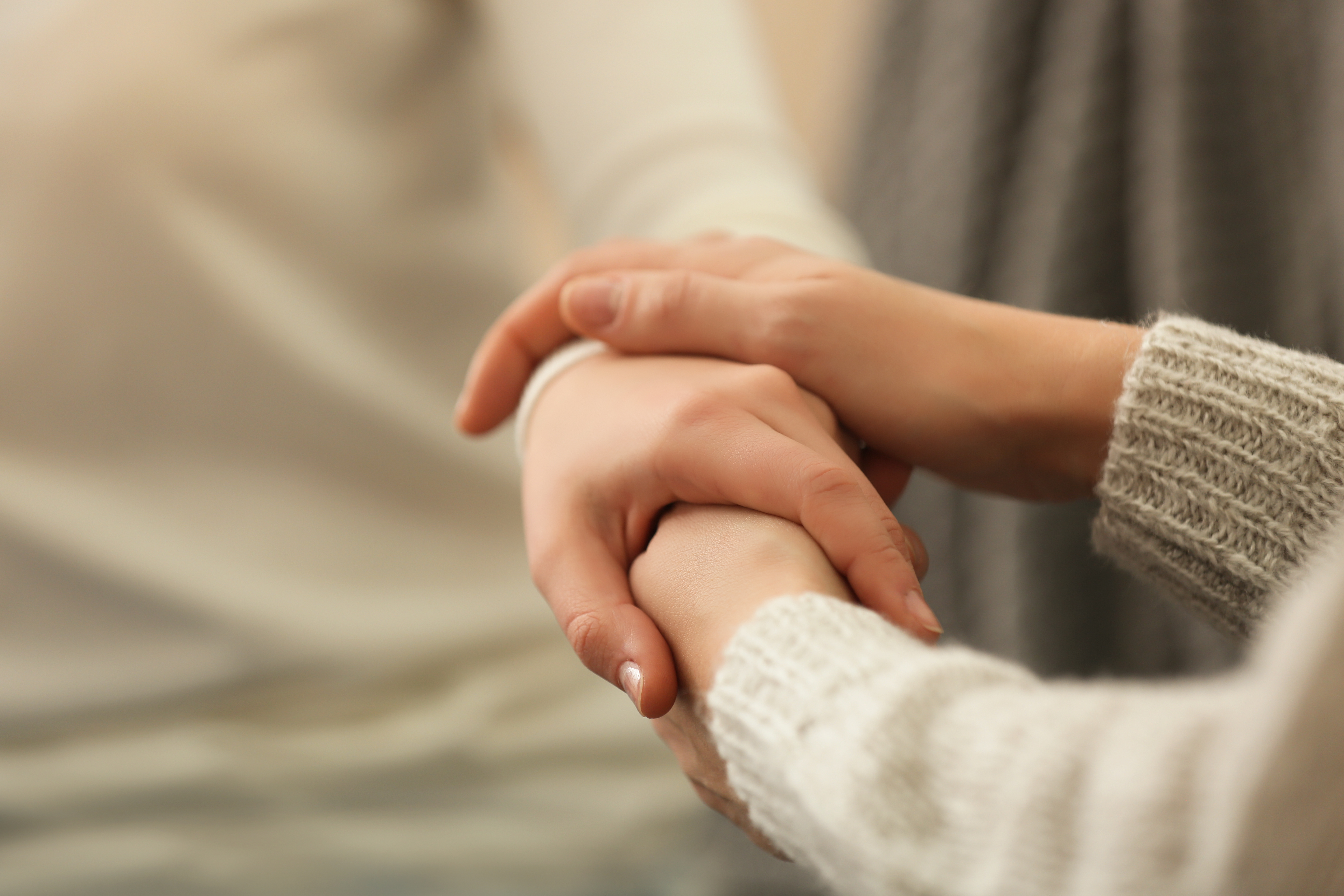 Two people hold hands.
