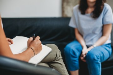 Psychotherapy session, woman talking to his psychologist in the studio.