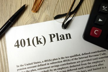 401k plan with calculator pen and glasses.