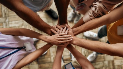 Women's hands together, unity