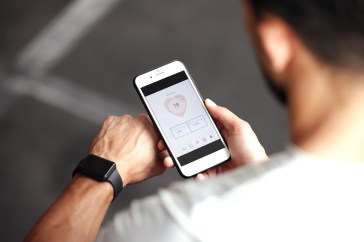 Fitness, app and man with phone, smart watch and workout schedule online at gym and sports training. Athlete with digital application, heart rate tracker and tech for exercise and health on cellphone.