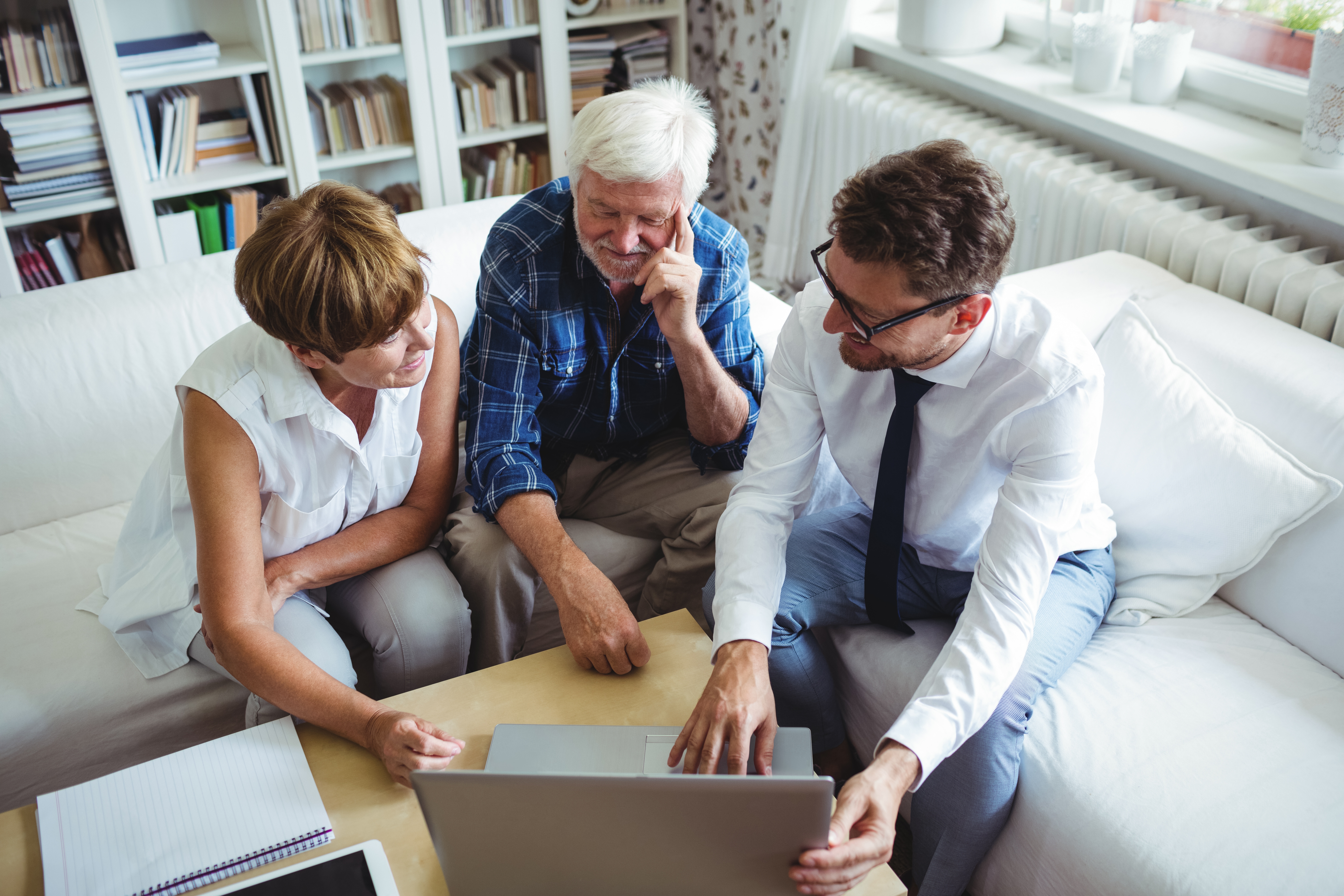 Senior couple planning their investments with financial adviser.