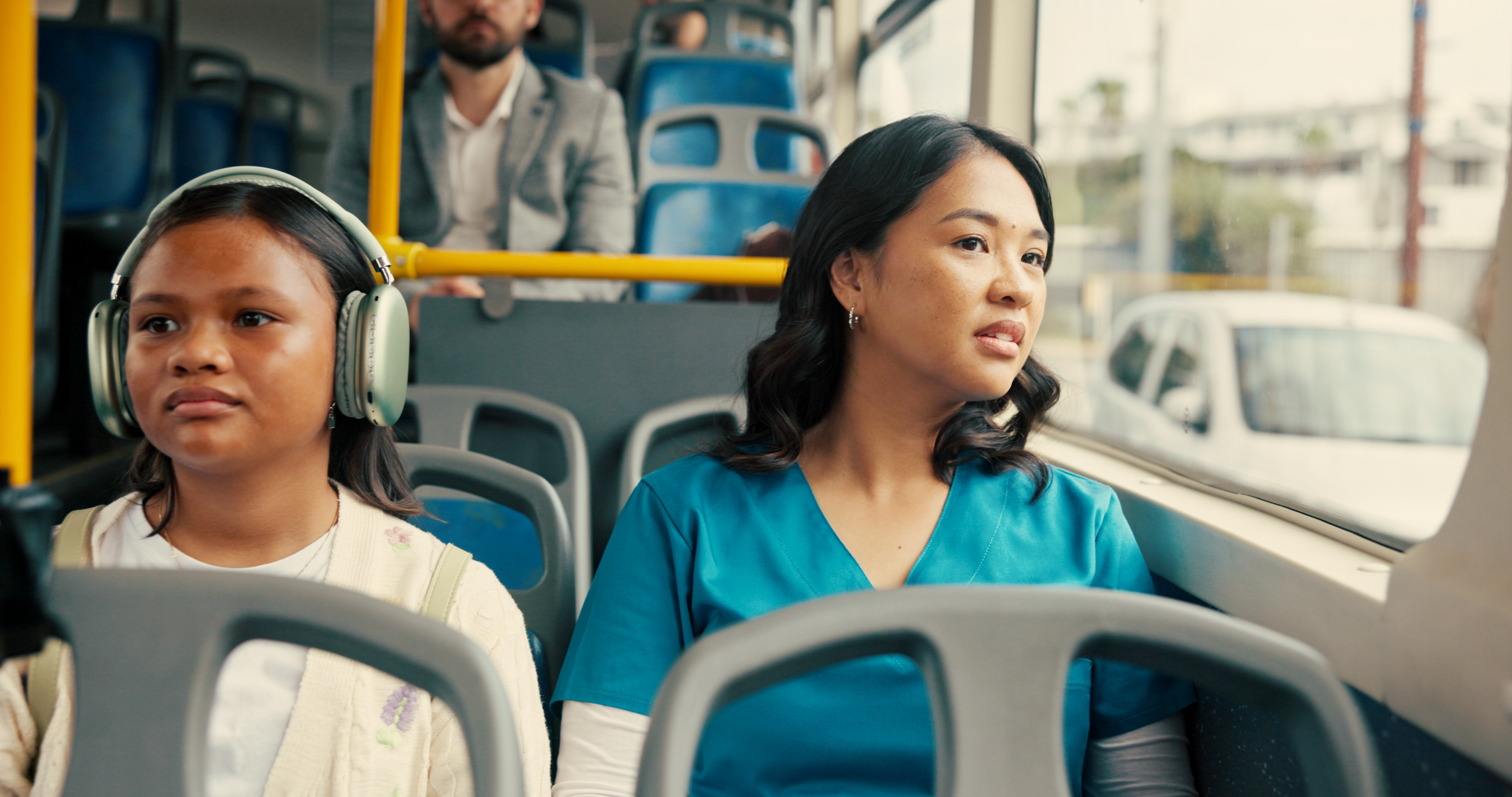Woman in scrubs riding bus