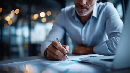 Faceless businessman manage digital procurement process with business contract invoice approval documents, representing B2B sourcing vendor management supply chain e-procurement, defocused.