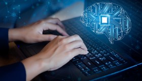 Person typing on computer with design on screen