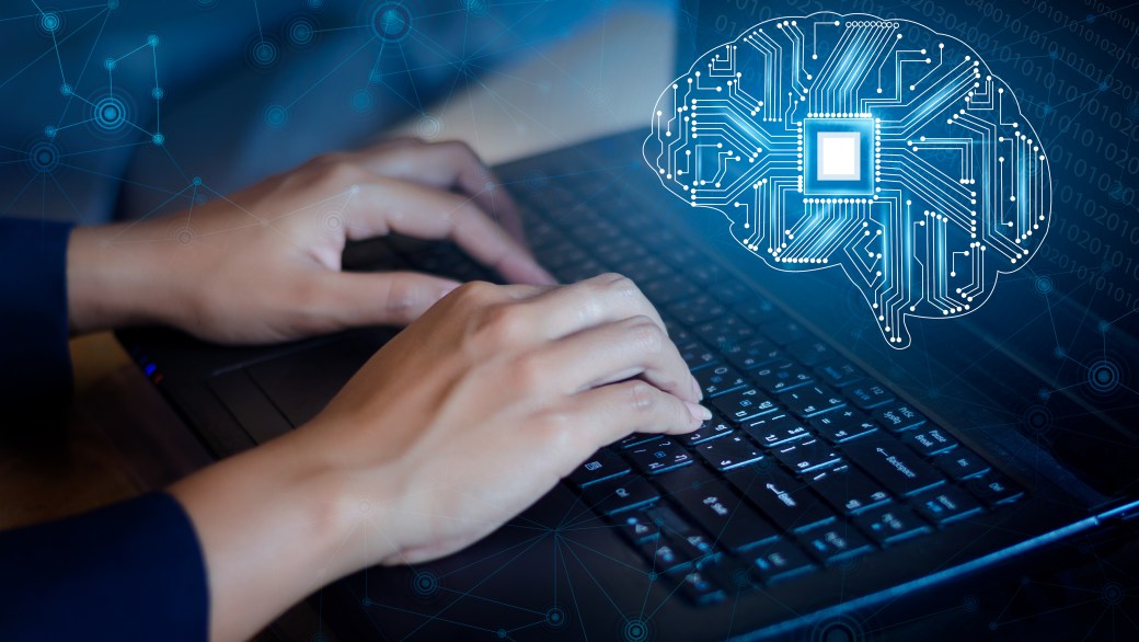 Person typing on computer with design on screen