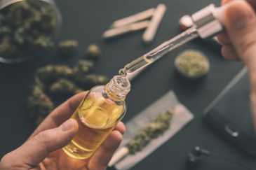 Medicinal marijuana in liquid, being put in bottle with a dropper