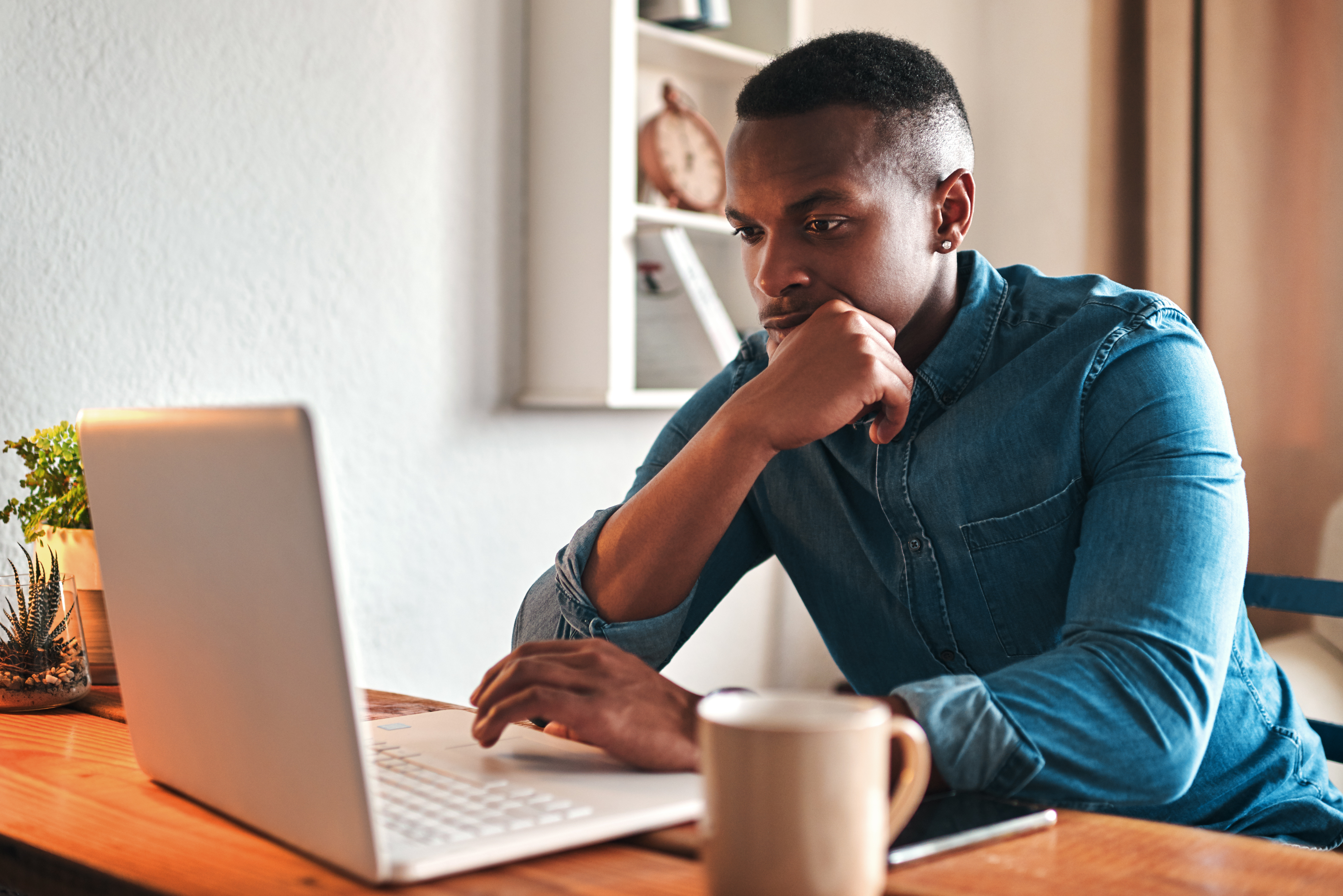 Man focused on work, looking at laptop