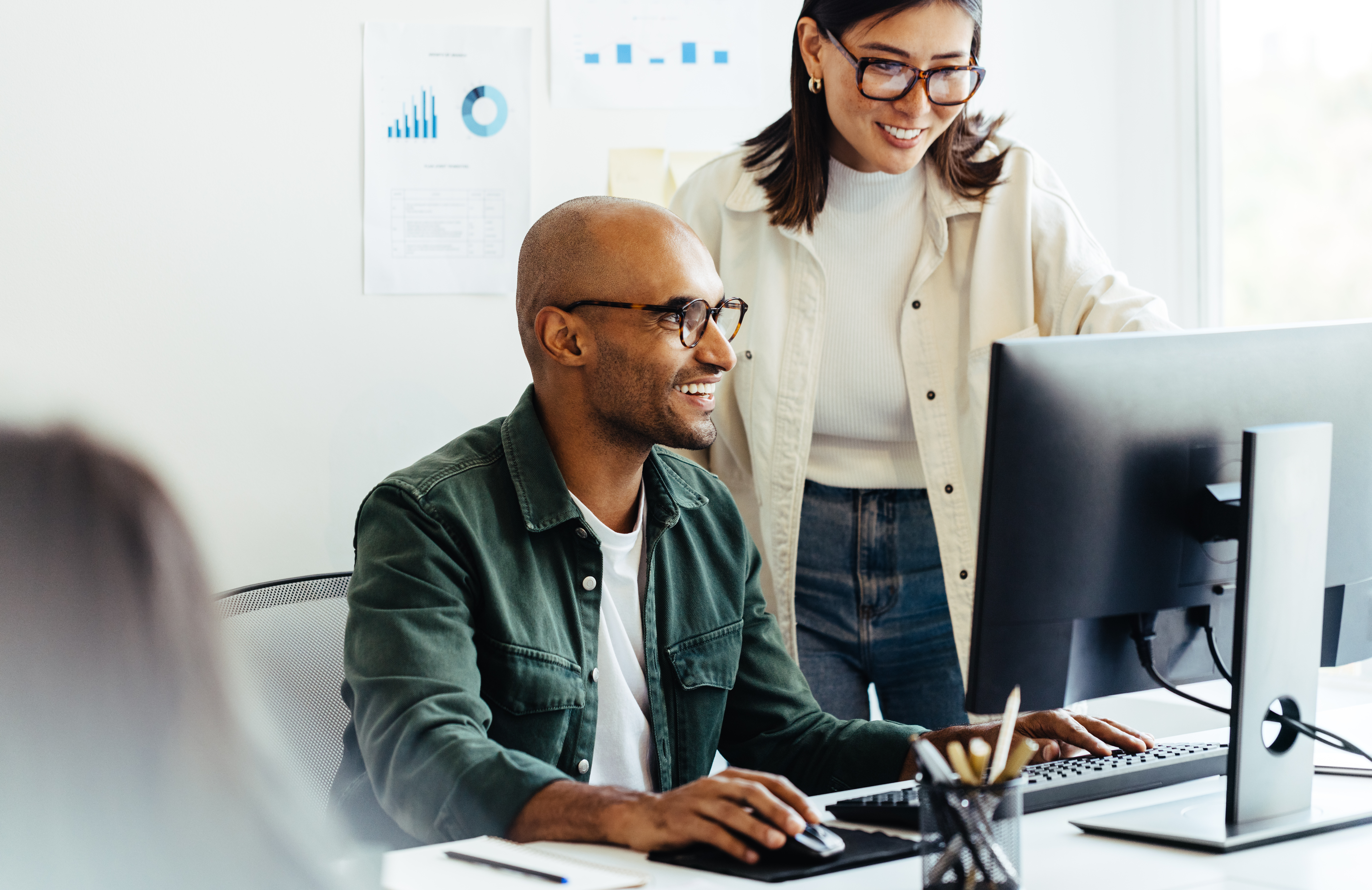 Two employees looking at computer