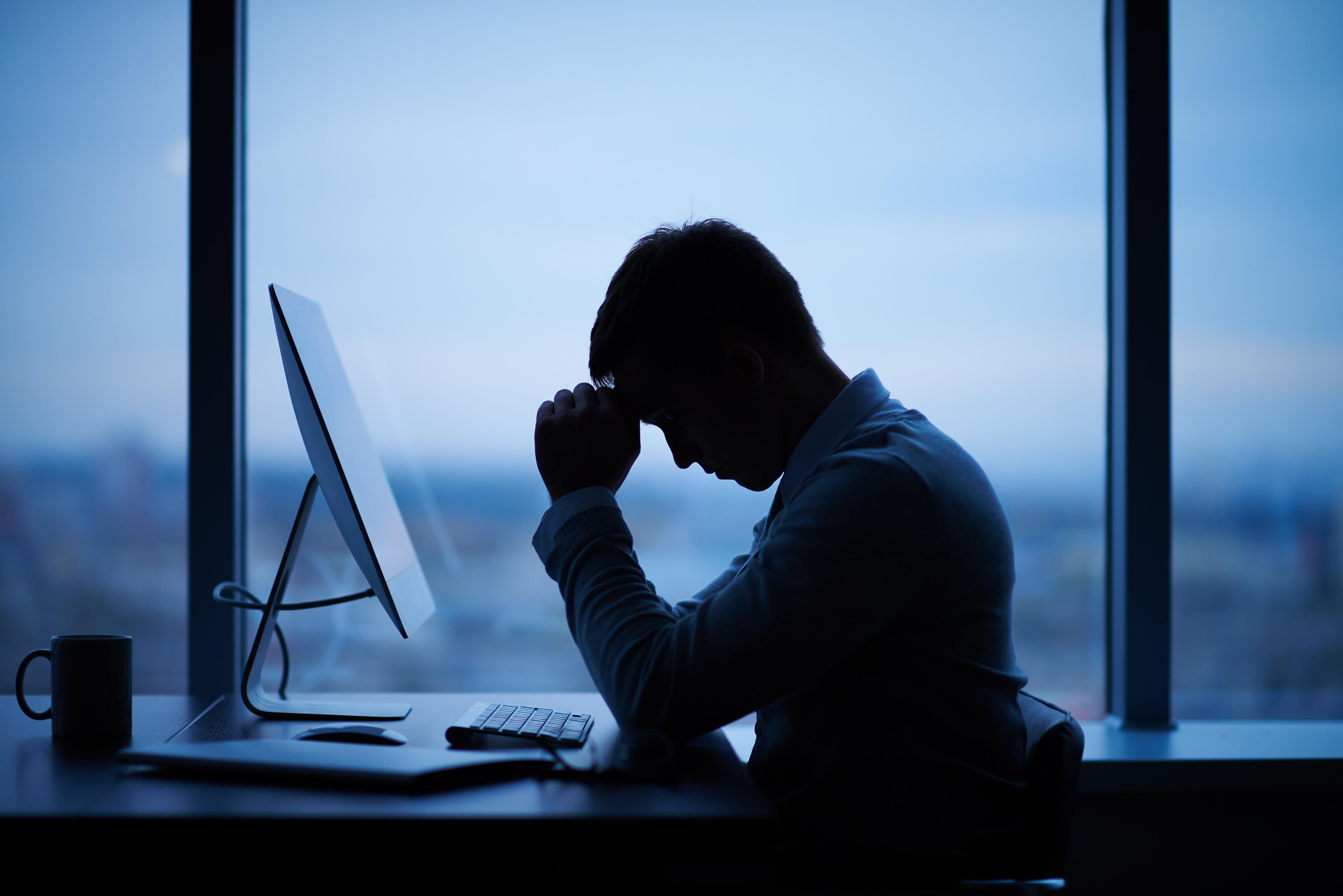 An employee working late at his desk.