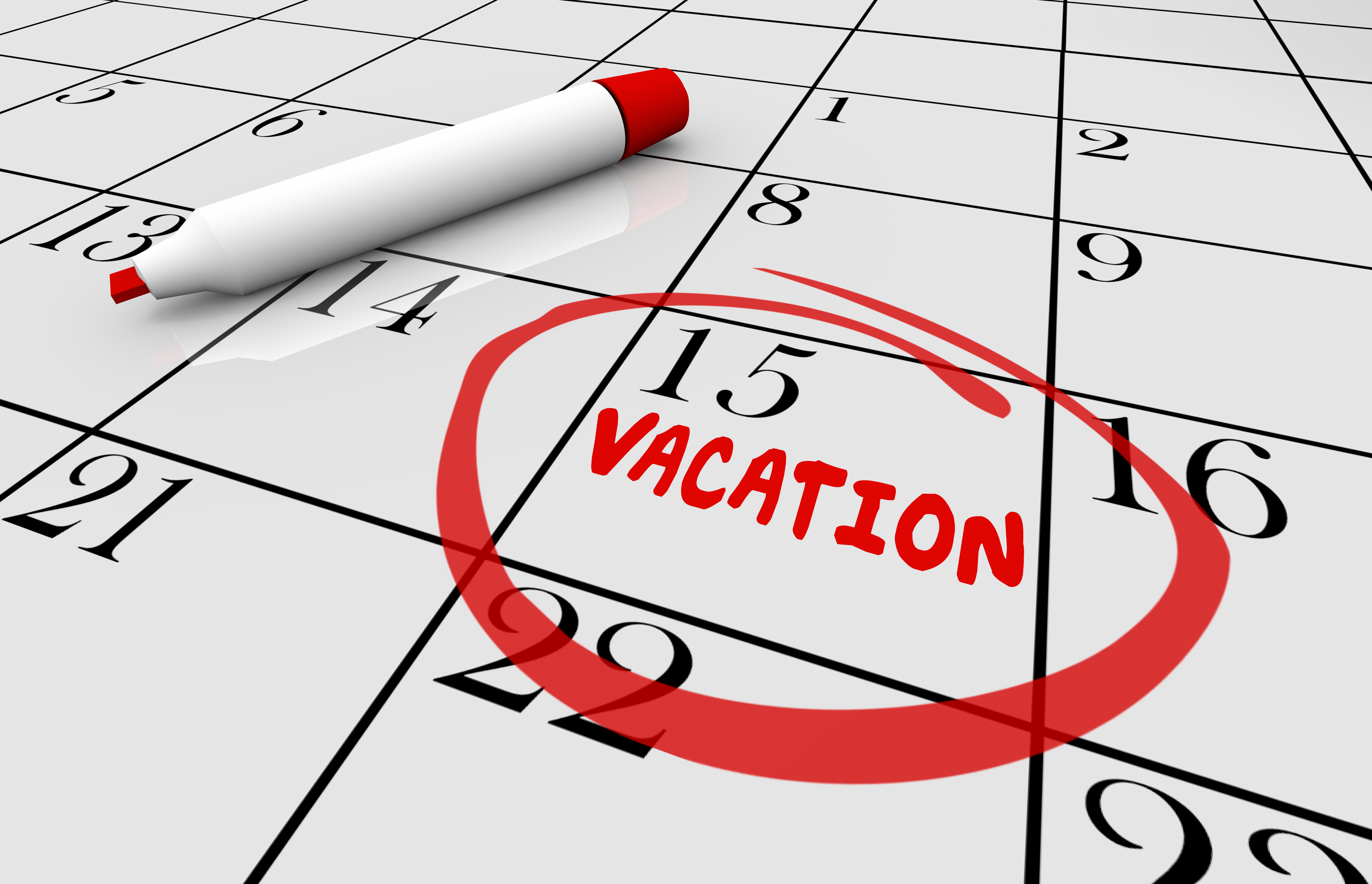 A calendar with the word "VACATION" circled on it.