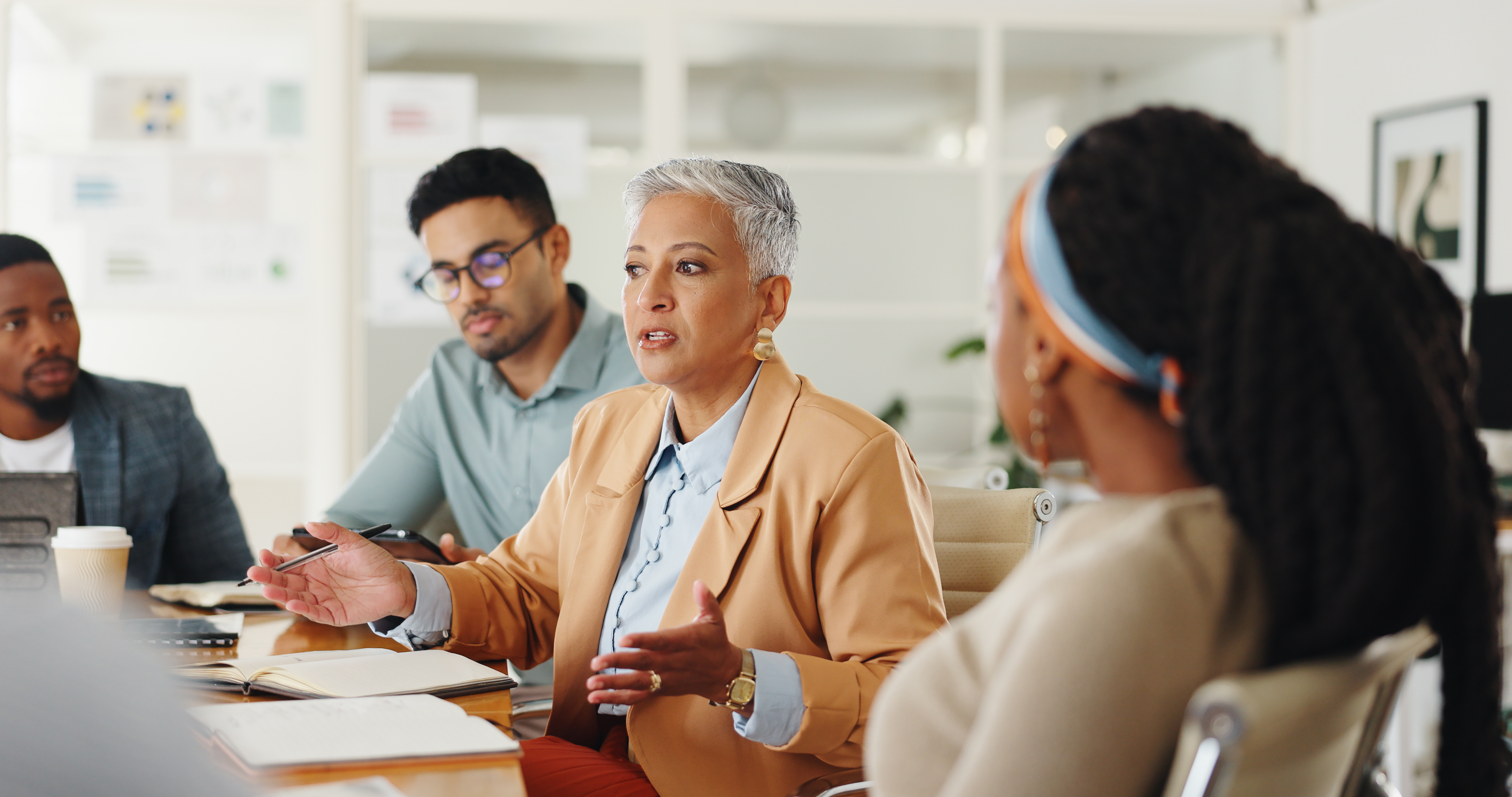 Group of employees talking at conference table
