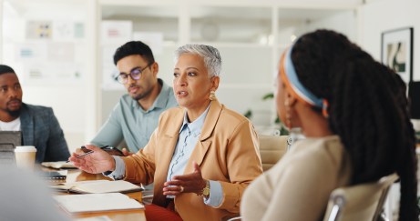 Group of employees talking at conference table