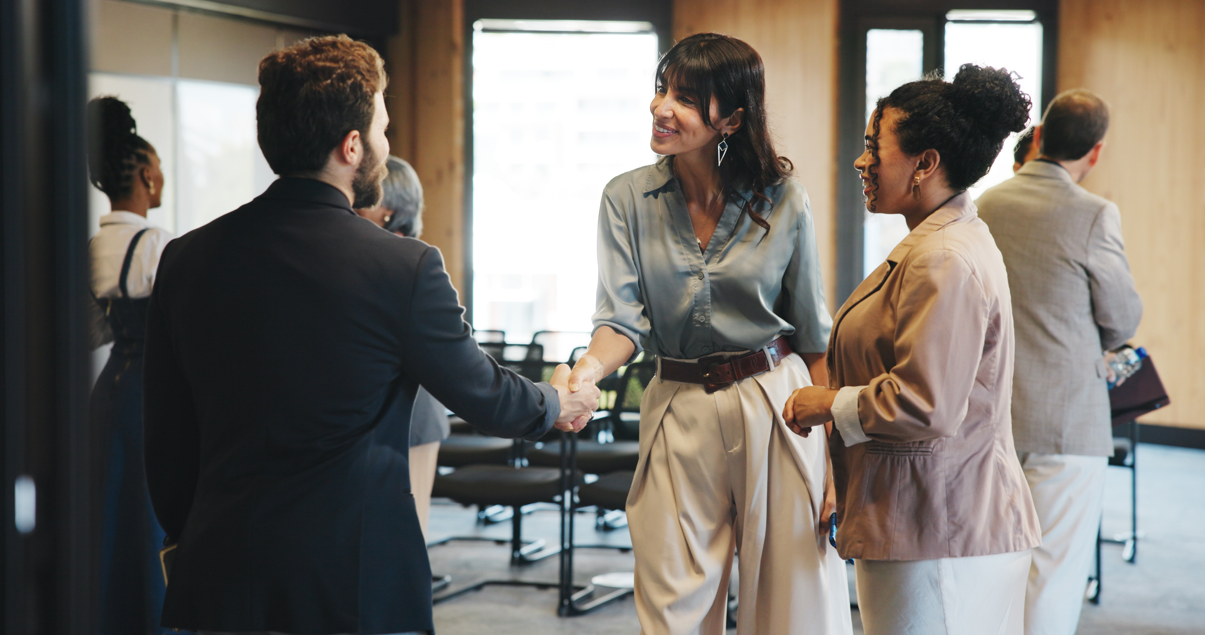Man and woman shaking hands at work, in office