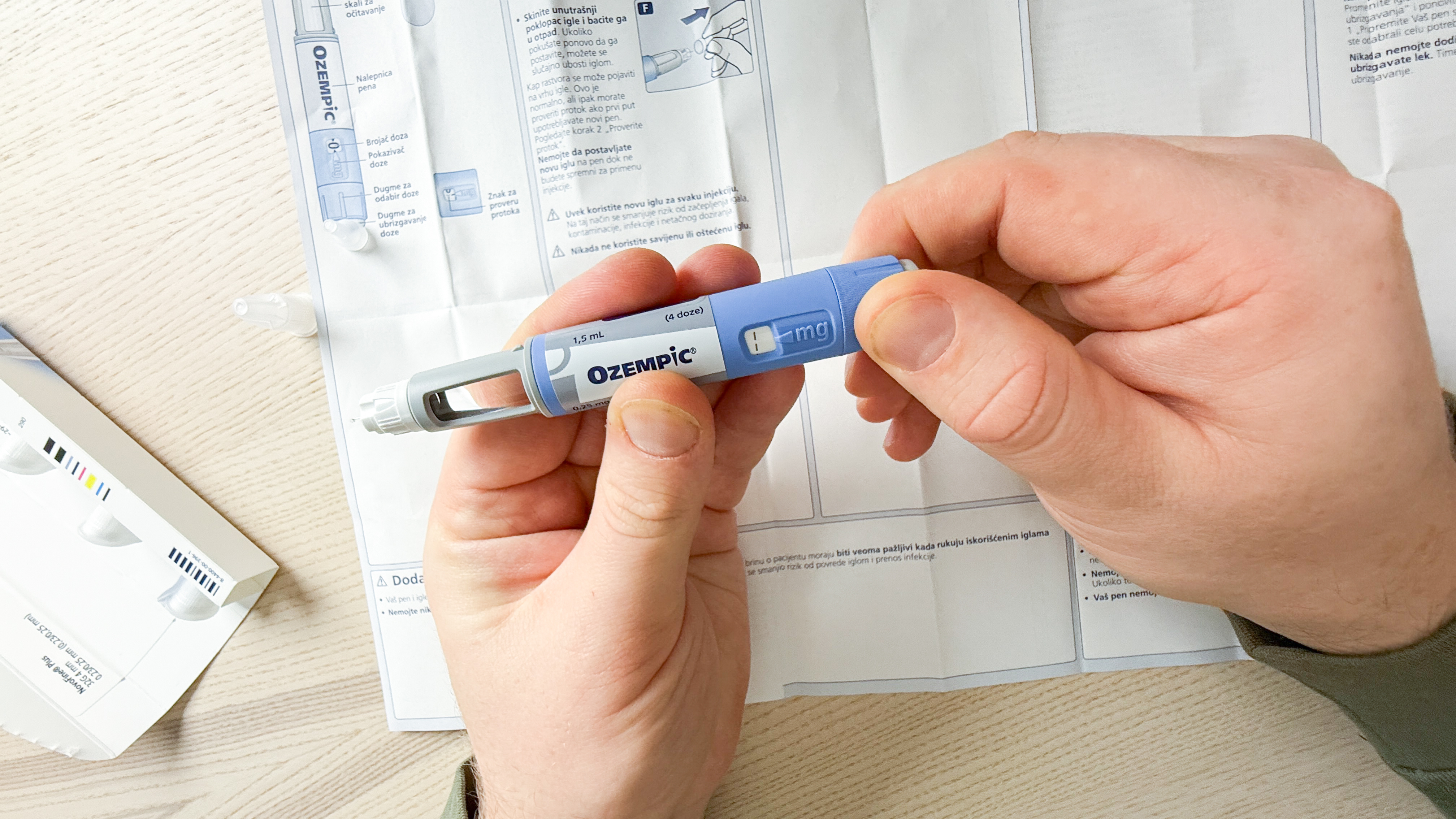 A meticulous Caucasian male examines an Ozempic pen, resembling a modern talisman for World Diabetes Day reflection.