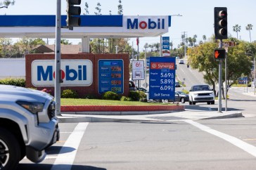 A Mobil gas station displays gas prices.