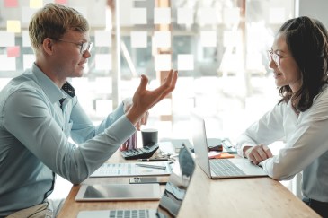 Business people discussing performance revenue in a meeting.