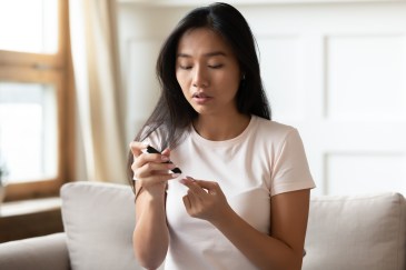 Woman doing home blood test