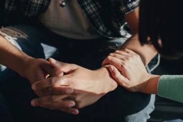 Woman consoling a man.
