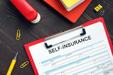 Conceptual photo about SELF-INSURANCE Application Form with handwritten phrase.