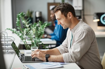 Man working at desk on laptop