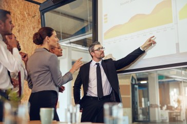 Employees looking at data on large chart