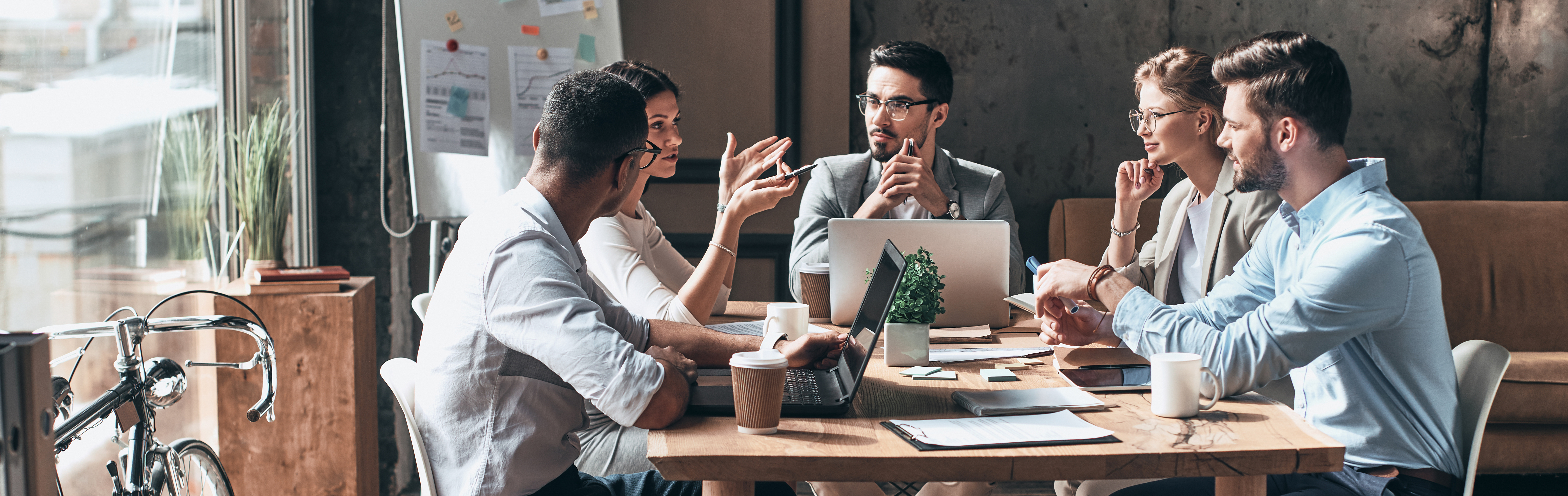 Group of employees sitting at conference table