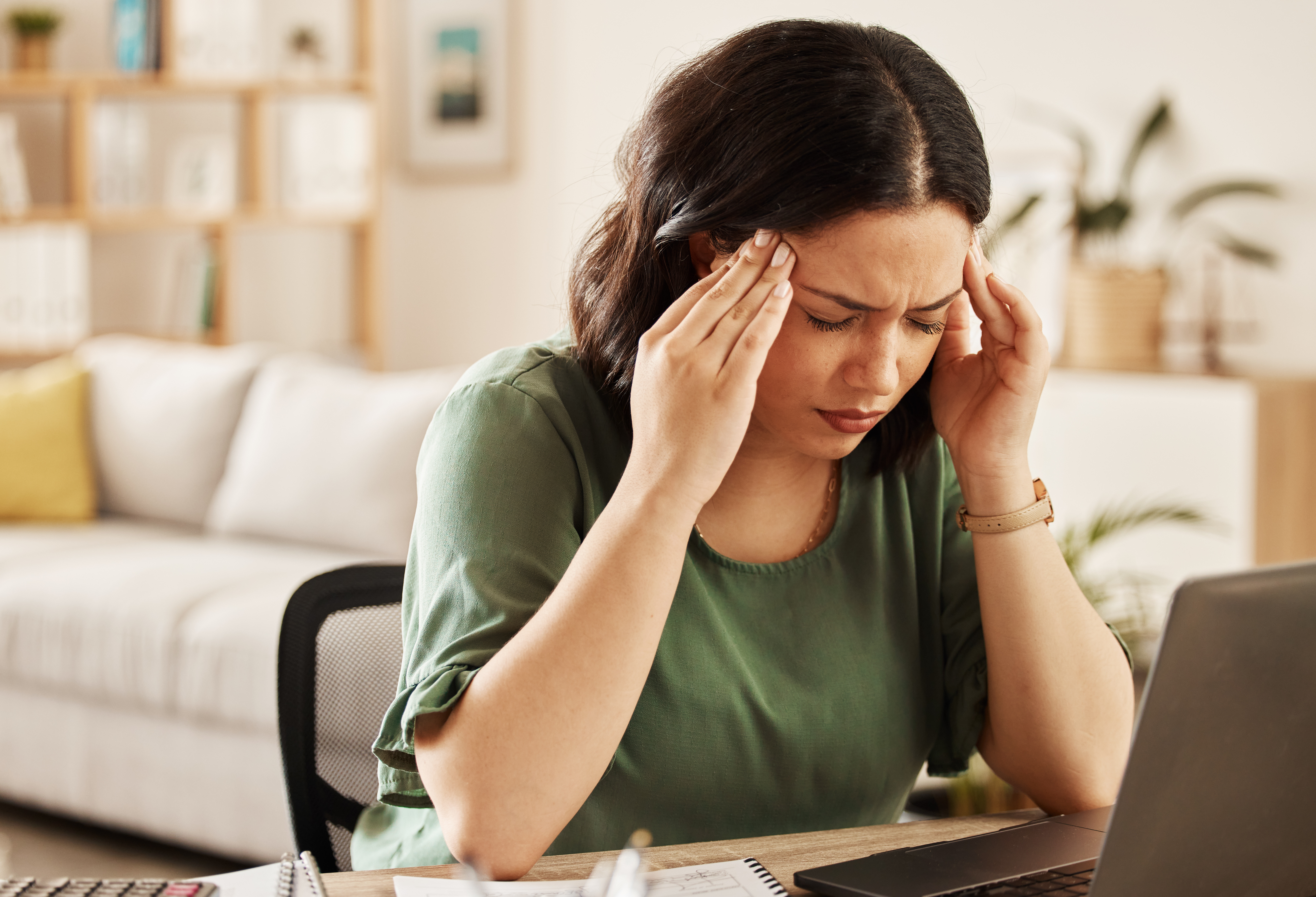 Woman holding temples, headache