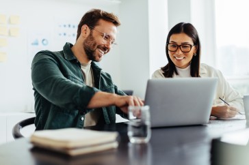 Two people working together on computer