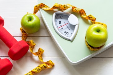 Scale, weights, apples and tape measure, healthy eating, weight loss tools