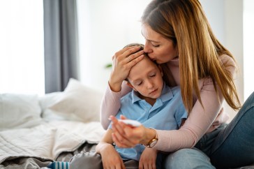 Mother holding sick child