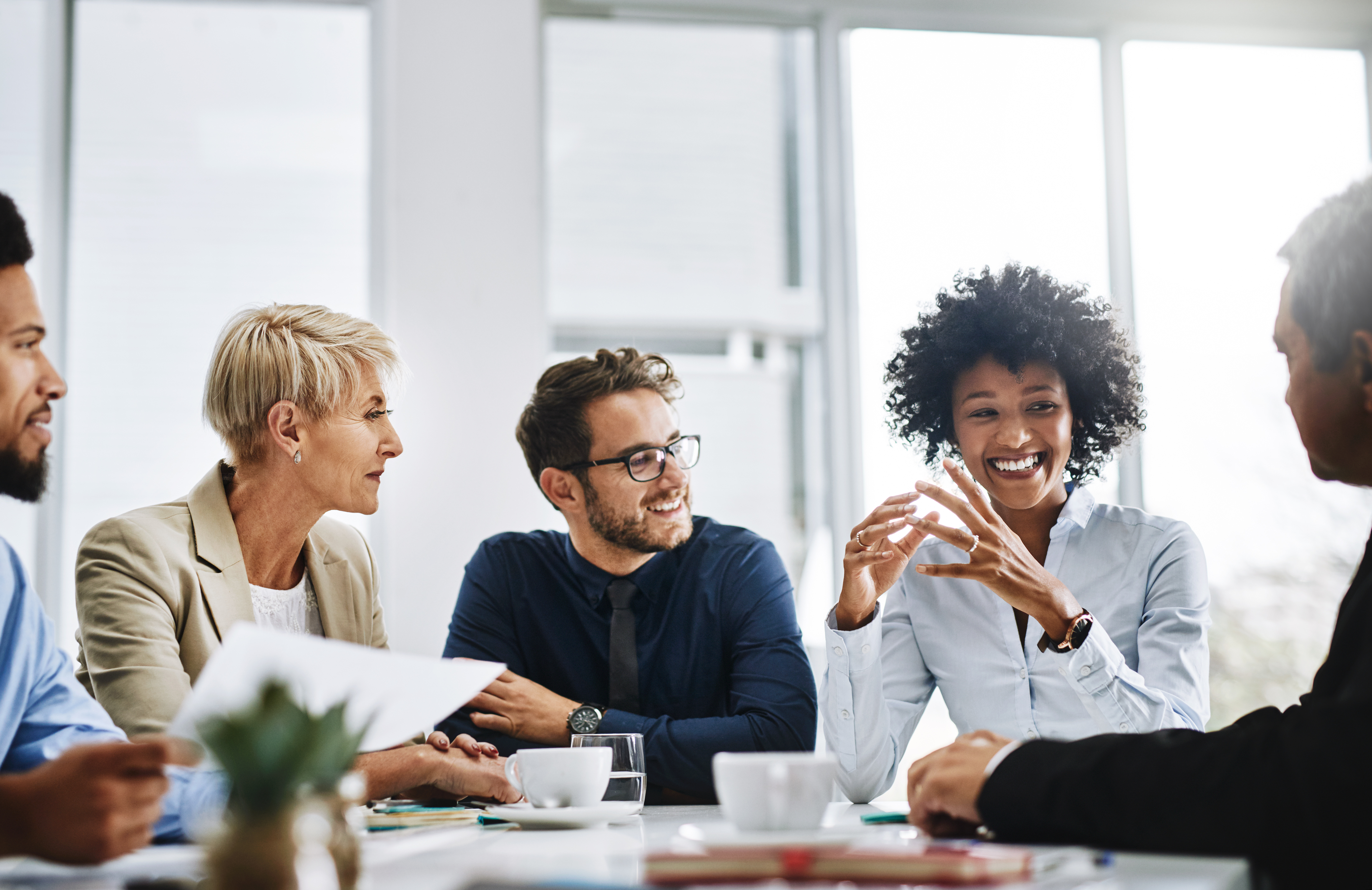 Group of employees talking at table