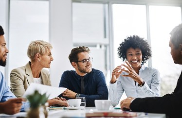 Group of employees talking at table