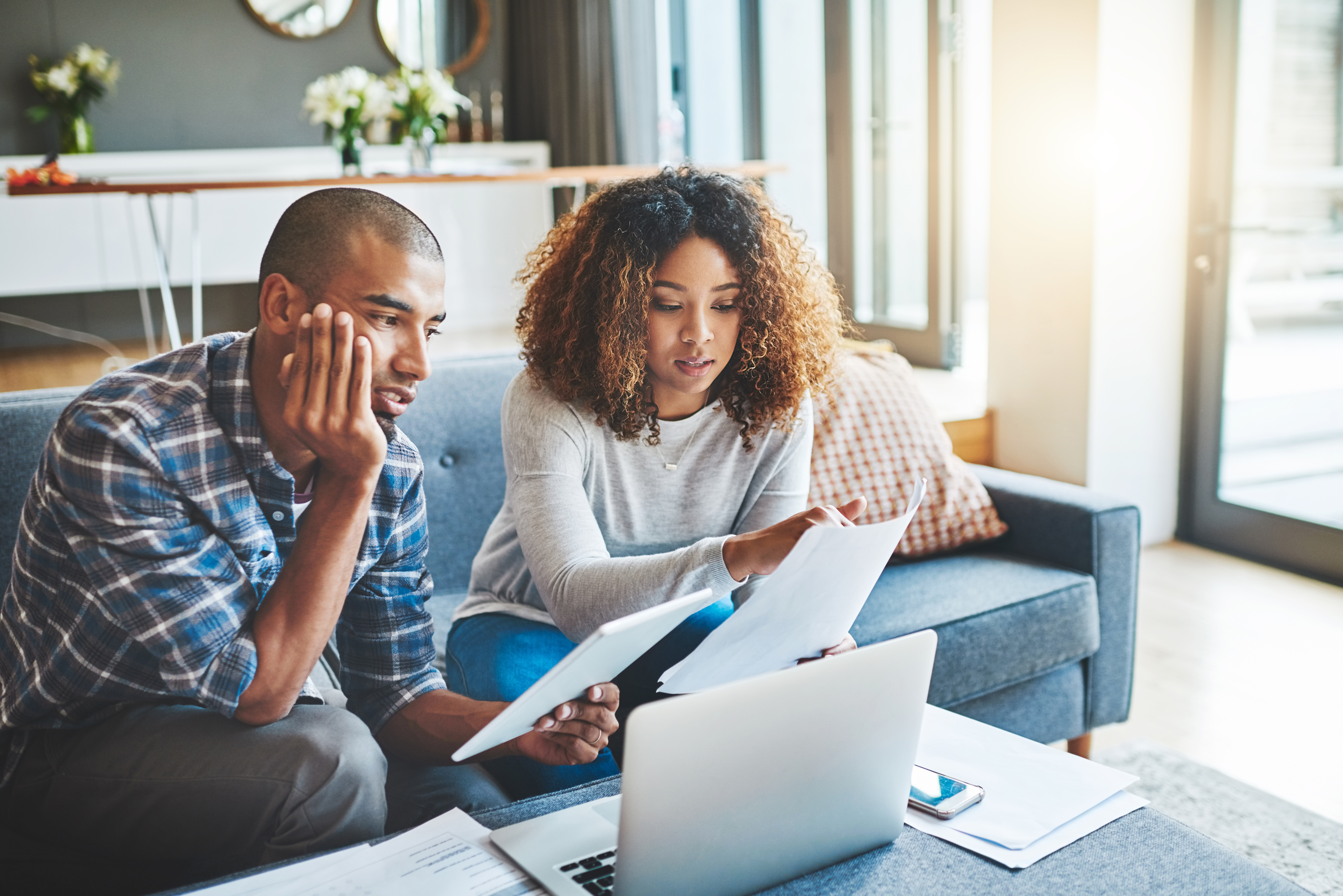 Couple looking over bills, stressed
