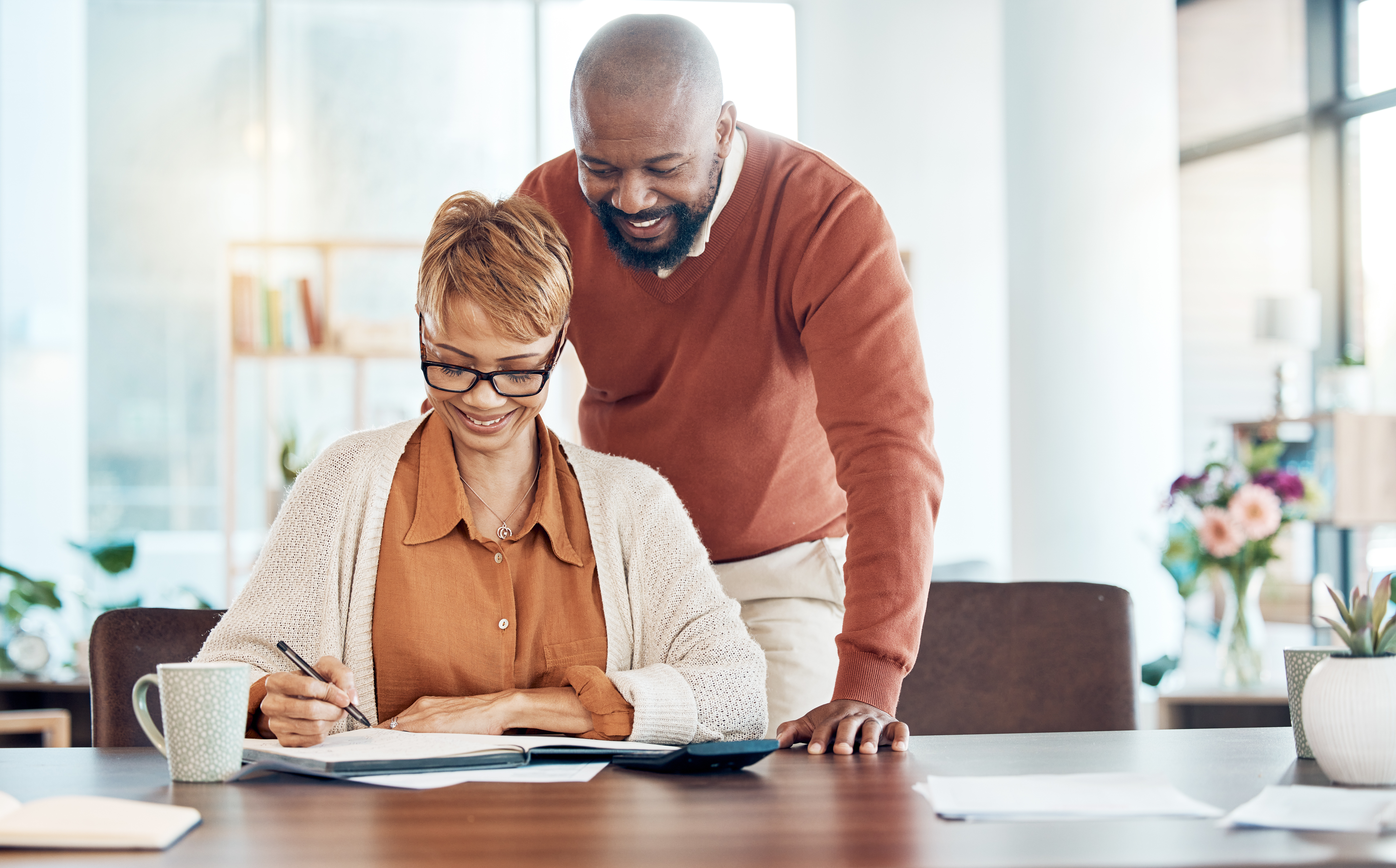 Black couple, budget and check savings for investment, retirement plan and smile together. Man, woman and manage finance for retired years, banking for future and happy with money growth and profits.