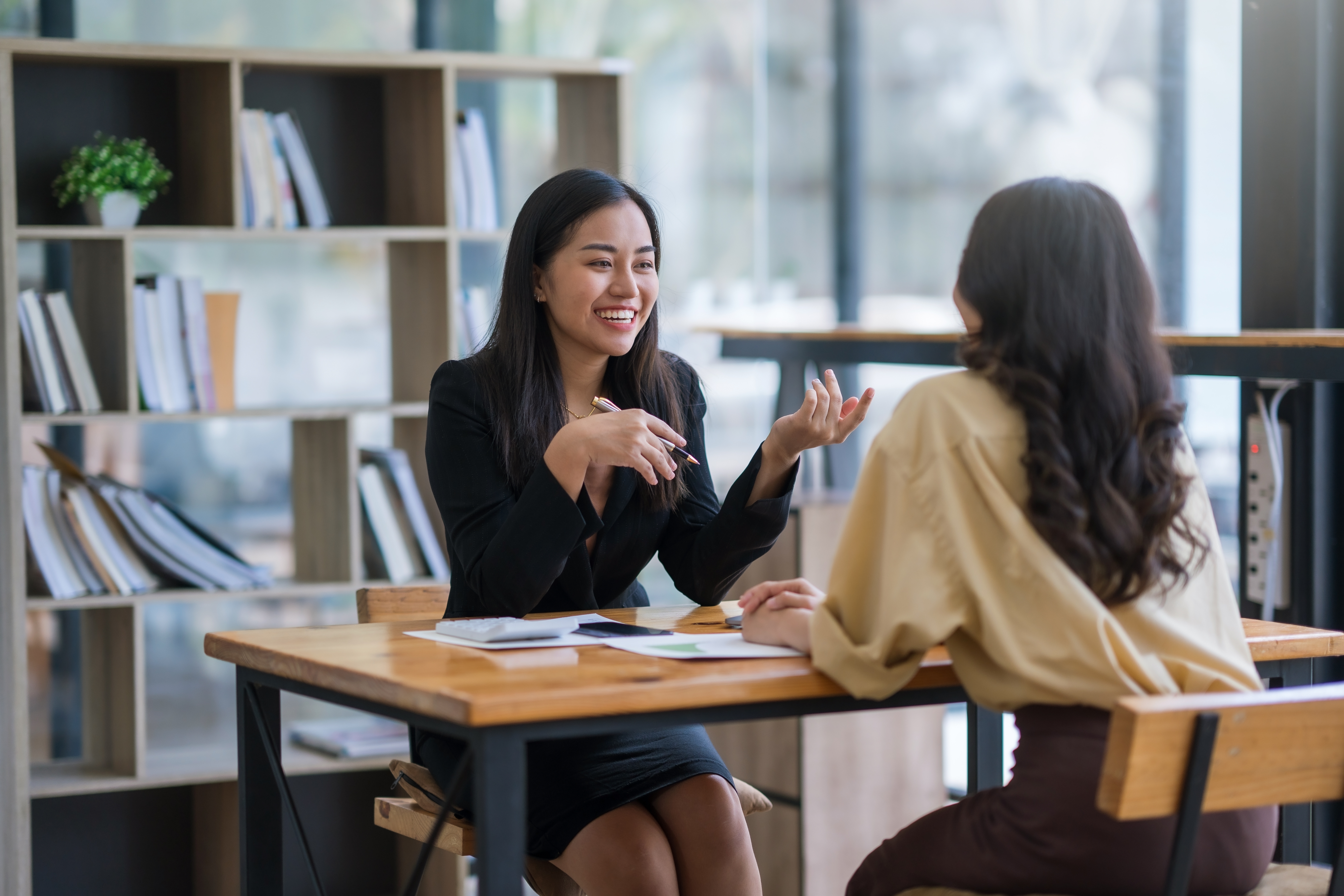 Two female employees talking